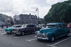 Havana, Cuba, 2016 - Vintage American cars parked in front of the Castillo de la Real Fuerza, one of the oldest existing forts in the Americas: a Chevrolet of 1955, a Mercury of 1954 and a Chevrolet of 1948.