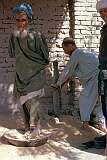 Preparing grain before it can be used to bake “nan”, the Afghan bread, it has to be pounded and stirred around to remove the chaff, a job for the old men who do it with their feet!