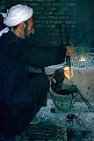 Pouring molten brass from the crucible into the moulds requires a steady pair of hands. Each mould produced two ornaments that were obtained by breaking the mould after the brass had cooled and solidified.