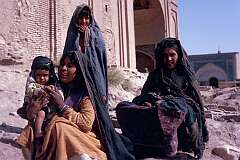 Women and girls of the Kuchi people, one of the nomadic peoples of Afghanistan, near a mosque on the outskirts of Herat. Kuchi women don't wear the all-covering “burqa”.