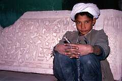 The boy with the key at the sarcophagus in the tomb of Gawhar Shad, the empress who built the “madrassa” or religious school of which now only four minarets remain.