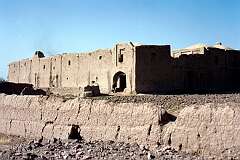 An old crumbling fortress near Herat. The building is, like the wall around it, made of mud brick.