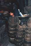 In Kabul's bazaar in Kabul a boy sells bowls of manure that will be used as fuel.