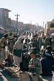 A street market in the bazaar of Kandahar. Large round slabs of “nan”, Afghan bread, are for sale in the foreground. In this strict Muslim society, the market is an all-male affair.