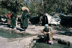 A camp of the Kuchi nomadic people near Kandahar. The women seem to live a fairly free life and do not wear the all-enveloping “chaderi" or “burqa”.