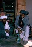 Kandahar, southern Afghanistan: Preparing the water-pipe in a tea house in Kandahar, an important ritual in Afghanistan. In the background the large brass samovar and many tea pots