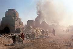 Just outside Kandahar is the village of Deh Khatay, where bricks, cut from clay by hand, are baked in large stone kilns.