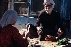 Preparing minced meat and onions for a stew outside one of the many small eating places in Mazar.