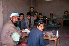 A teacher and his students in a small school, open to the street, in Mazar-e-Sharif. These boys were later heard chanting passages from the holy Qur'an.