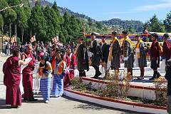 The student dancers receive a “khata” ceremonial shawls around their neck by a monk, as appreciation, after their performance.