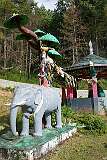 Display of the traditional tale of the elephant, monkey, goat and bird at a Buddhist shrine,  west of Thembang Village.