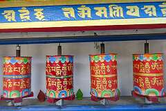 Prayer wheels at Tawang Monastery, inscribed "Om Mani Padme Hum" ("Hail to the Jewel in the Lotus"), the most famous mantra in Tibetan Buddhism, associated with the Bodhisattva of Compassion, Avalokiteshvara.