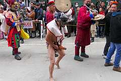 A masked dancer with large wooden phallus, in the Carnival Parade on the last day of the Tawang Festival.