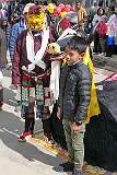 A boy posing with a masker dancer after the Carnival Parade on the last day of the Tawang Festival.