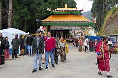 The gate to the Upper Gontse Gaden Rabgyel Ling Monastery, with people leaving after the first day of the Torgya temple festival.