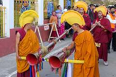Monks with ceremonial headdresses with two “dungchen”, a long horn.