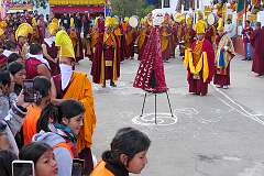 Monks with ceremonial headdresses and the “Torma”, spiritual cake.