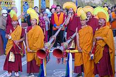 Monks with ceremonial headdresses with two “dungchen”, a long horn.