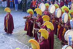 Monks with pairs of Cymbals and Ritual Drums at the place where the “Torma”, spiritual cake, will be burnt.