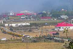 The bride and women friends and relatives arriving along Bullo Village Road for the Eli ceremony in Tajang Village.