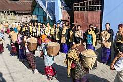 Women with baskets of rice, for the rice barn in the Apatani village of Tajang, at the start of the Eli ceremony.