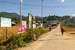 Announcements at the turnoff to the Biilii Lembo road, in Bulla Village, looking east.