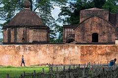 The octagonal temple and cells resembling Assamese type huts covered by do-chala roofs of  Talatal Ghar, a royal palace of the Ahom Kings. It was built by the King Rajeswar Singha (1751-1769 CE).