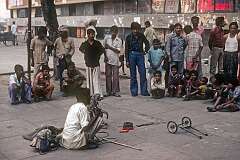 A man performing with a monkey, street theatre in New delhi.