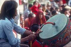 Playing the “Dhyangro” drum accompanying the Tibetan Opera.