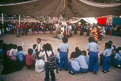 The finale in a Tibetan Opera, a boy draped with “khatag” ceremonial shawls between his parents, the other participants and crowd during the festivities celebrating 19 years of the Tibetan Children's Village in McLeod Ganj, Dharamshala.