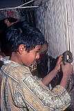 A boy working on a carpet in Narayan Bagh.
