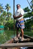 Karathra Kadavu, puntering the boat on the backwaters of Munroe Island.