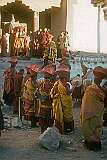 The abbot of the monastery with a “damaru”, small two-headed drum on the steps and monks with cymbals.