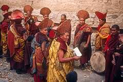 Reading Buddhist texts from one of the loose-leaf books, during the ceremony.