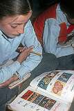 A Kashmiri girl reading in Tibetan.