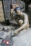 A representation of a Konyak blacksmith at work. Guns,'daos' and other items were all made this way using indigenous bellows, stone hammers and anvils.