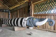 The log drum in the Morung, traditional 'bachelors' dormitory' house of the Phom Naga tribe in Kisama Heritage Village. It has a carved elephant's head.