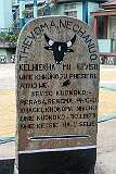 Commemorative sign in the Angami Naga language at the central plaza of the upper village of Khonoma.