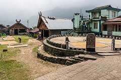 View to the central plaza and square in Khonoma, with traditional Angami Naga houses and drying rice.