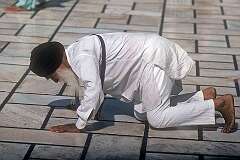 An elderly Sikh man, prostate in the courtyard at the Golden Temple, the Harmandir Sahib, the holiest Gurdwara and the most important pilgrimage site of Sikhism.