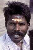 A man with his face painted with a sacred “tika” at the Brihadisvara Temple in Thanjavur.