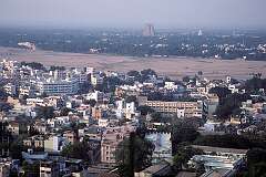 Tiruchirappalli seen from the Rock Fort temple with, on the other side of the Kaveri River,  the gopuram or temple towers of the Sri Rangathaswamy Temple in Srirangam.