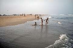 Young boys playing in the sea on Gandhi Beach.