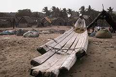A log boat in front of a village at Santhome Beach in Chennai.
