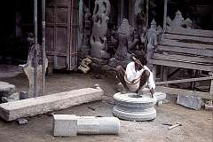 A sculptor carving a “yoni”, the sacred Hindu symbol representing the divine feminine creative energy.