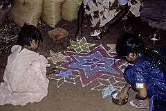 A “Kolam”, traditional rice-paste design is made by women and girls on their doorstep in the early morning in Rameswaram.