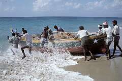 Fishermen launching their wooden boat in Dhanushkodi.