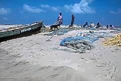 Fishermen and their nets on the beach in Dhanushkodi, an abandoned town on the south-eastern tip of Pamban Island, east of Rameswaram.