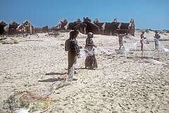 Women with fishing nets on the beach in Dhanushkodi, the town that was destroyed during the 1964 cyclone.