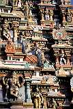 Detail of one of the richly decorated “gopuram” or gateway towers, covered with figures of divinities, celestial beings, monster masks, guardians, and animal mounts.